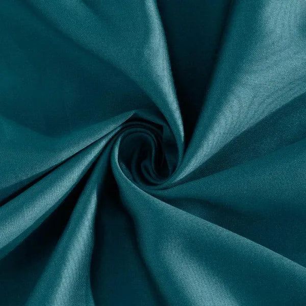 Close up of the material of the Teal-Licious, a solid blue-green super king size bedsheet you can buy online at Sukham Home, a sustainable furniture, gardening and home decor store in Kolkata, India