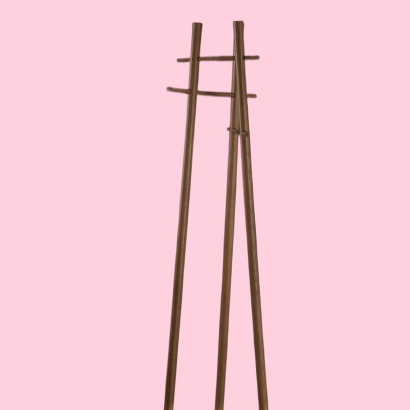 Against a pink background, the Walnut Natural Scarecrow, a wooden entryway designer quirky coat hanger you can buy online at Sukham Home, a sustainable furniture, kitchen & dining and home decor store in Kolkata, India