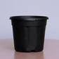 Close up of the 5 inch black nursery pot and gardening tools you can buy online at Sukham Home, a sustainable furniture, gardening and home decor store in Kolkata, India