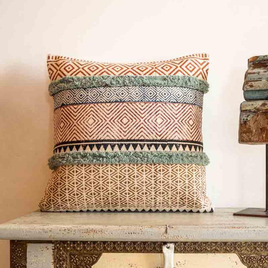 Placed on a bench, the Abstract Fantasy Cushion, a cotton handpainted and tufted accent pillow you can buy online at Sukham Home, a sustainable furniture, kitchen & dining and home decor store in Kolkata, India