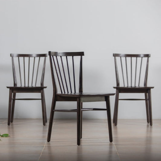Three of the Walnut Natural Air Chair, a solid wood Windsor dining seat you can buy online at Sukham Home, a sustainable furniture and home decor store in Kolkata, India