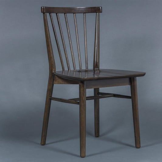 Against a grey background, the Ash Grey Air Chair, a solid wood Windsor dining seat you can buy online at Sukham Home, a sustainable furniture and home decor store in Kolkata, India