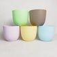Colourful pots from Verona, a round colourful indoor planter made from plastic that you can buy online at Sukham Home, a sustainable furniture, gardening and home decor store in Kolkata, India