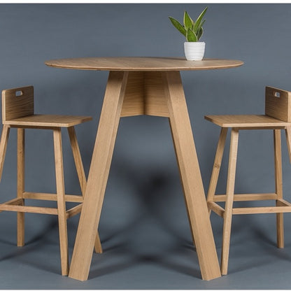 With the Flamingo Bar Stools, the Alpine, a wooden high round bar table you can buy online at Sukham Home, a sustainable furniture, kitchen & dining and home decor store in Kolkata, India