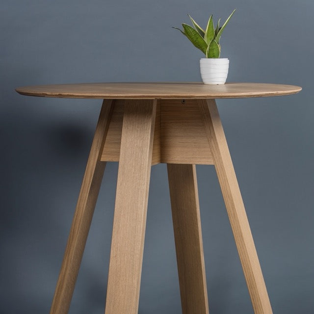 In Oak Natural, the Alpine, a wooden high round bar table you can buy online at Sukham Home, a sustainable furniture, kitchen & dining and home decor store in Kolkata, India