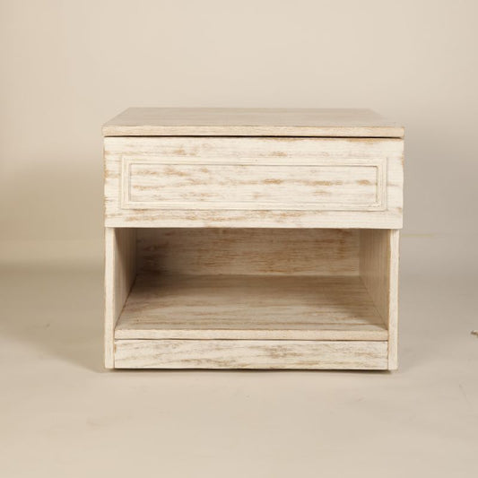 Front view of the Archaic Bedside Table, a wooden white patina nightstand inspired by harbour and coastal style furniture you can buy online at Sukham Home, a sustainable furniture, kitchen & dining and home decor store in Kolkata, India