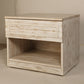Tilted angled view of the Archaic Bedside Table, a wooden white patina nightstand inspired by harbour and coastal style furniture you can buy online at Sukham Home, a sustainable furniture, kitchen & dining and home decor store in Kolkata, India