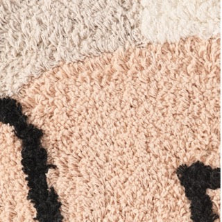 Close up of the Art-Inspired Tufted Cushion, a square pink, grey, white and black accent pillow available at Sukham Home, a sustainable furniture, kitchen & dining and home decor store in Kolkata, India