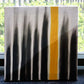 Placed by a window, The Light I Seek painting, a yellow, black and white canvas artwork you can buy online at Sukham Home, a sustainable furniture, kitchen & dining and home decor store in Kolkata, India