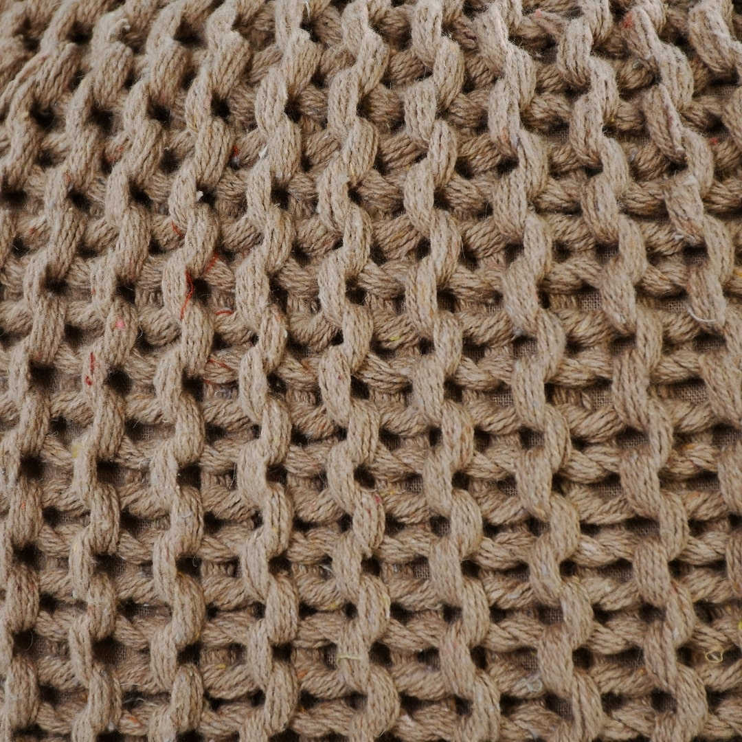 Close up of the texture on the Beige Knitted Pouf, an sandy brown ottoman made from cotton, available at Sukham Home, a sustainable furniture, kitchen & dining and home decor store in Kolkata, India