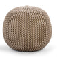 Against a white background, the Beige Knitted Pouf, an sandy brown ottoman made from cotton, available at Sukham Home, a sustainable furniture, kitchen & dining and home decor store in Kolkata, India