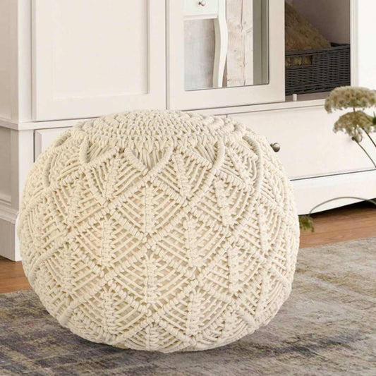 Placed on a carpet, the Beige Macrame Pouf, a white ottoman made from cotton, available at Sukham Home, a sustainable furniture, kitchen & dining and home decor store in Kolkata, India
