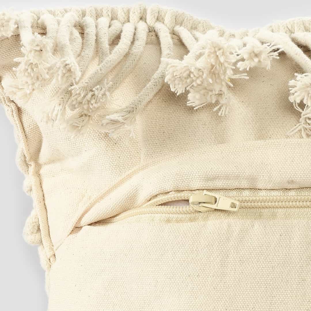 Close up of the zip of the Beige White Macrame Cushion, a rectangle accent pillow you can buy online at Sukham Home, a sustainable furniture, kitchen & dining and home decor store in Kolkata, India