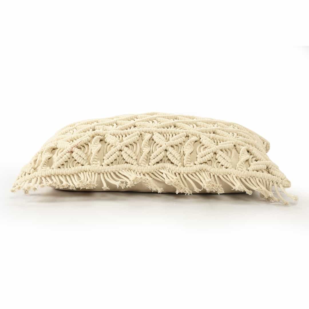 Against a white background, the sideview of the Beige White Macrame Cushion, a rectangle accent pillow you can buy online at Sukham Home, a sustainable furniture, kitchen & dining and home decor store in Kolkata, India