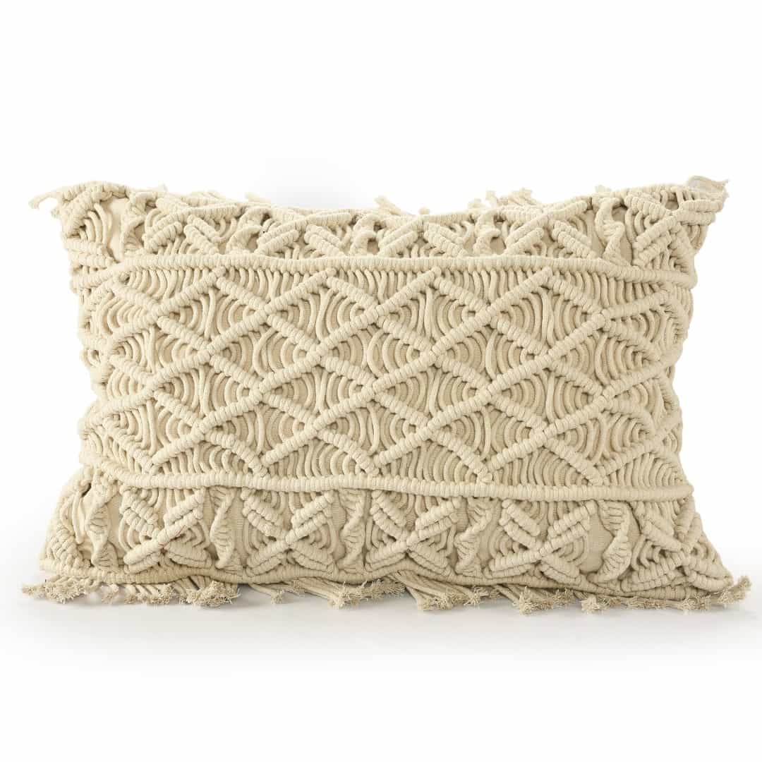 Against a white background, the Beige White Macrame Cushion, a rectangle accent pillow you can buy online at Sukham Home, a sustainable furniture, kitchen & dining and home decor store in Kolkata, India