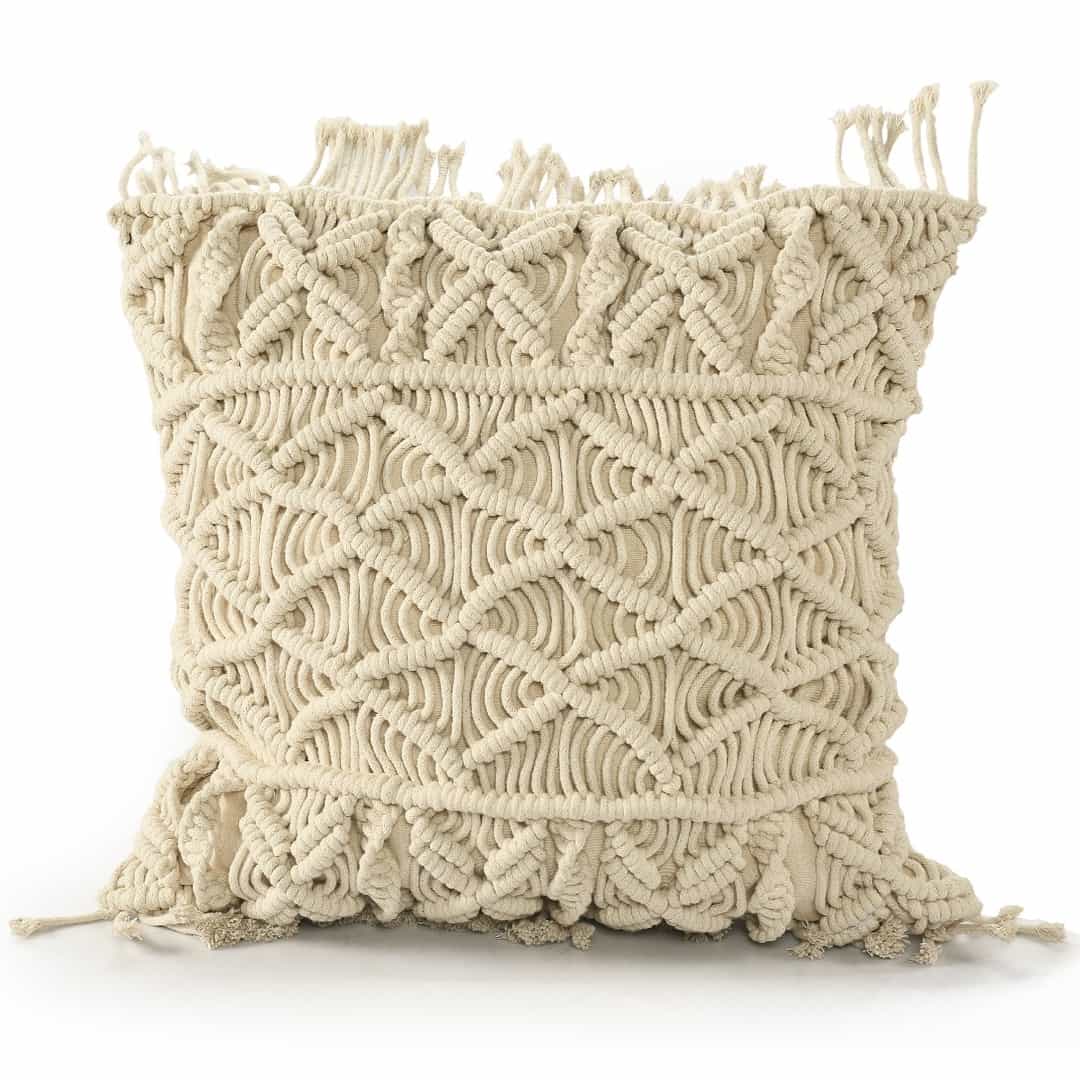 Against a white background, the Beige White Macrame Cushion, a square accent pillow you can buy online at Sukham Home, a sustainable furniture, kitchen & dining and home decor store in Kolkata, India