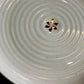 Close up of the gold flakes on the Beige Ganga Dinner Plate - a beige and 24-karat gold ceramic plate you can buy online at Sukham Home, a sustainable furniture, gardening and home decor store in Kolkata, India