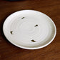 Close up of the gold flakes on the Beige Ganga Quarter Plate, an off-white and 24-karat gold ceramic small plate you can buy online at Sukham Home, a sustainable furniture, gardening and home decor store in Kolkata, India