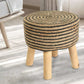 Placed on a carpet, Black Circle of Life Stool, a black ottoman made from jute, cotton and mango wood, available at Sukham Home, a sustainable furniture, kitchen & dining and home decor store in Kolkata, India