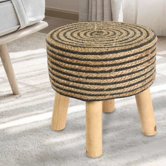 Placed on a carpet, Black Circle of Life Stool, a black ottoman made from jute, cotton and mango wood, available at Sukham Home, a sustainable furniture, kitchen & dining and home decor store in Kolkata, India