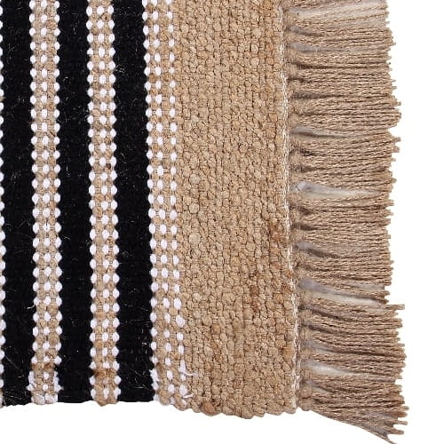 Close of the jute tassels on the Handwoven Jute Rug with Black and White Stripes and Tassels, a small rectangle jute and black & white cotton carpet you can buy online at Sukham Home, a sustainable furniture, kitchen & dining and home decor store in Kolkata, India
