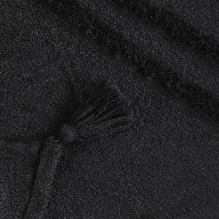 Close up of the texture on the Black Tufted Throw with Cushion Cover you can buy online at Sukham Home, a sustainable furniture, kitchen & dining and home decor store in Kolkata, India