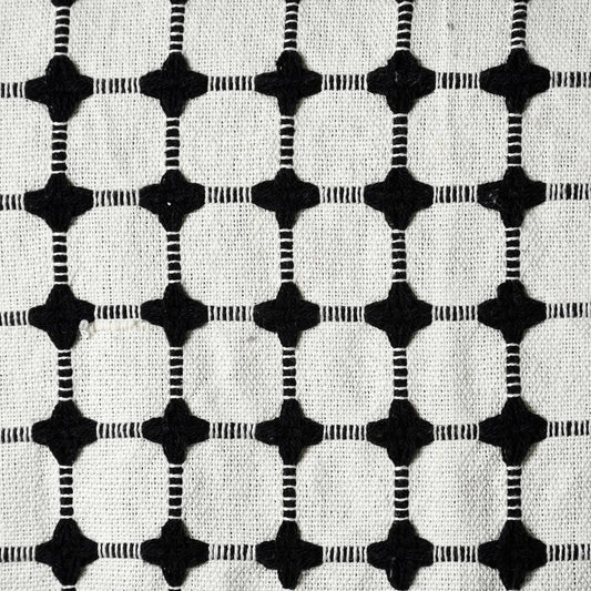 Close up of the woven pattern on the Black and White Cotton Bedcover Throw you can buy online at Sukham Home, a sustainable furniture, kitchen & dining and home decor store in Kolkata, India