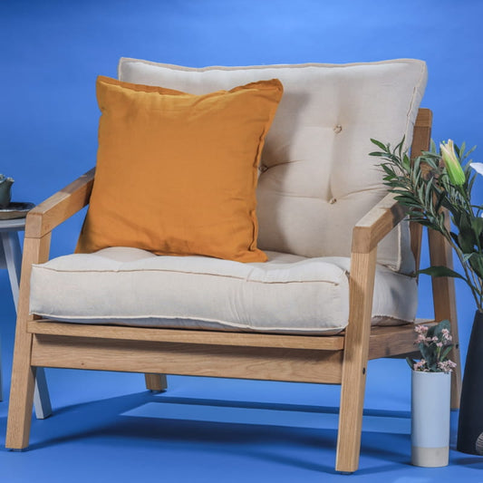 The whole set up of the Oak Natural Bliss Armchair, a wooden cushioned midcentury seat you can buy online at Sukham Home, a sustainable furniture, kitchen & dining and home decor store in Kolkata, India