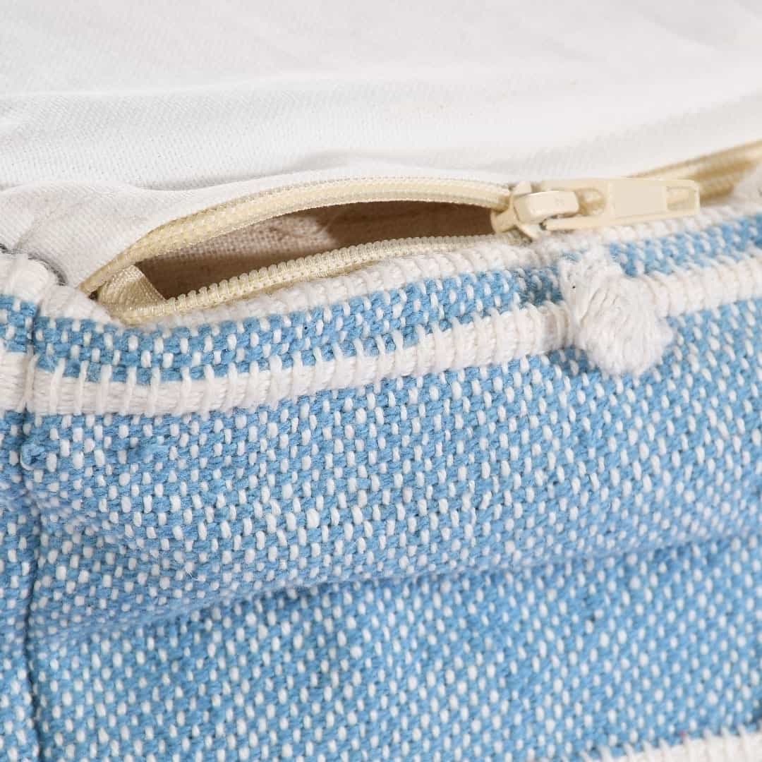 Close up of the zipper of the Geometric Details Blue Pouf, an ottoman made from cotton, available at Sukham Home, a sustainable furniture, kitchen & dining and home decor store in Kolkata, India