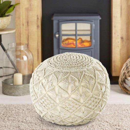 Placed on a shaggy carpet, the Bohemian Macrame Pouf, a white ottoman made from cotton, available at Sukham Home, a sustainable furniture, kitchen & dining and home decor store in Kolkata, India