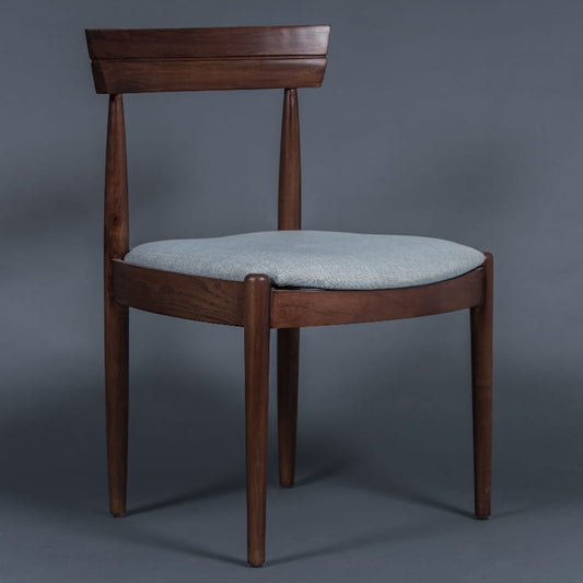 Using the Snow fabric, the Walnut Natural Bow, a solid wood chair with a padded cushion seat you can buy online at Sukham Home, a sustainable furniture and home decor store in Kolkata, India