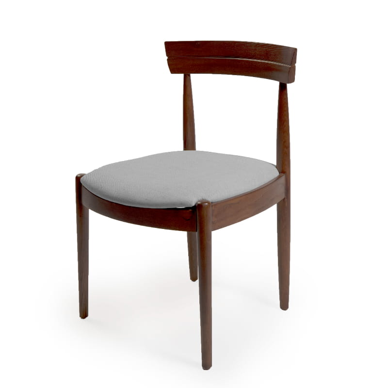 Against a white background, the Walnut Natural Bow, a solid wood chair with a padded cushion seat you can buy online at Sukham Home, a sustainable furniture and home decor store in Kolkata, India