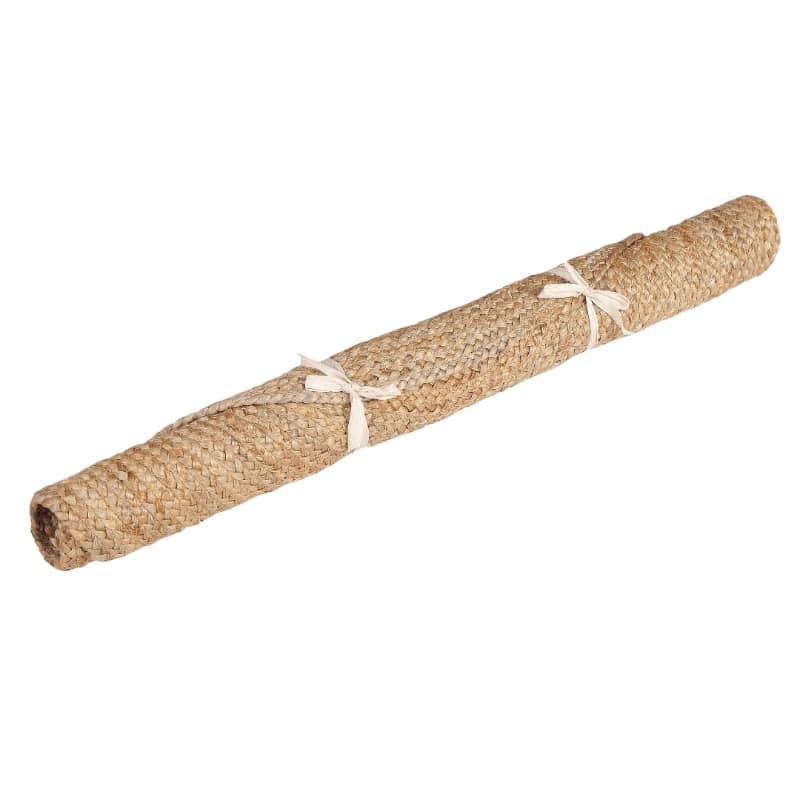Rolled up, the Braided Round Jute Rug, a circular jute carpet you can buy online at Sukham Home, a sustainable furniture, kitchen & dining and home decor store in Kolkata, India