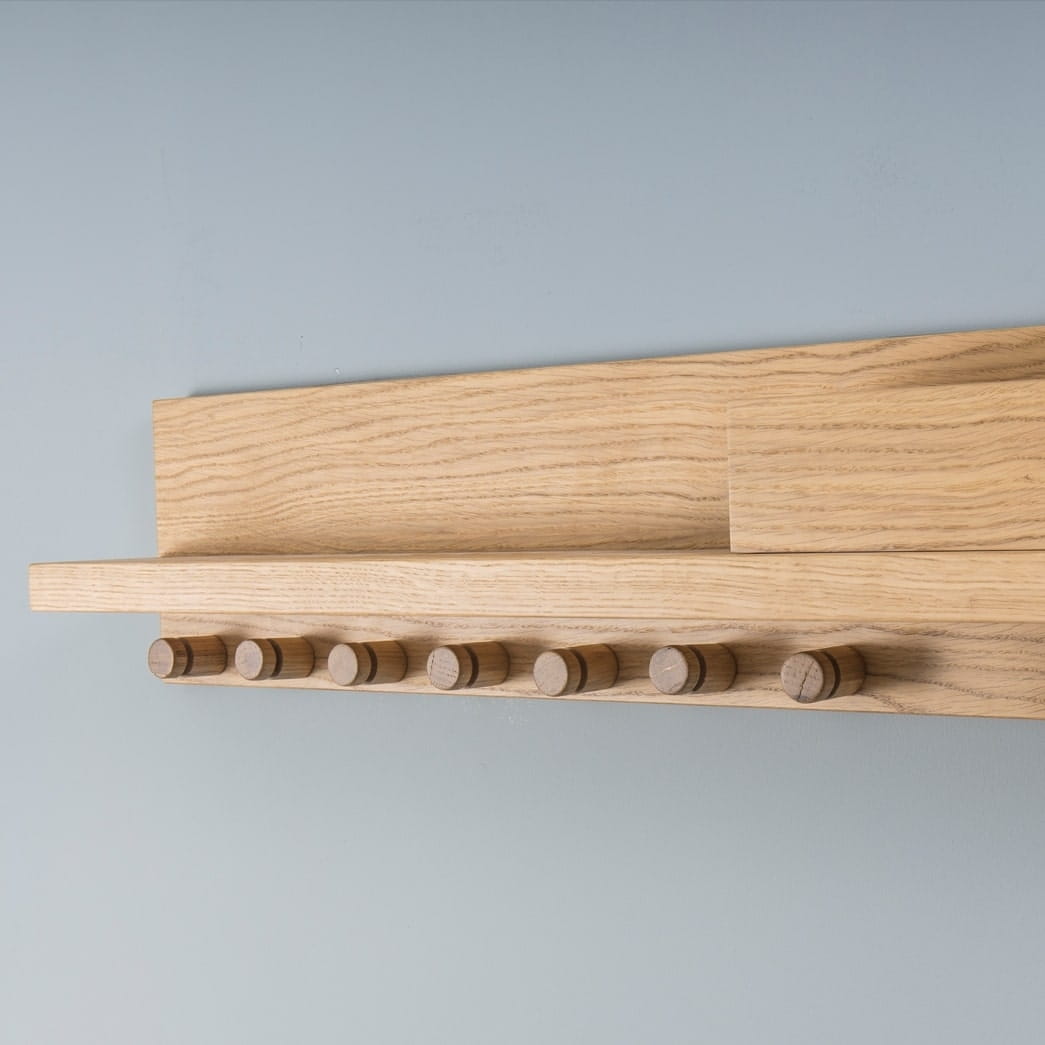 Close up of the Oak Natural Clasp, a wooden entryway coat hanger with a shelf and hooks you can buy online at Sukham Home, a sustainable furniture, kitchen & dining and home decor store in Kolkata, India