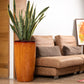 Glossy Teak Wood finish in the Cono, a large round tall textured luxury planter made from FRP you can buy online at Sukham Home, a sustainable furniture, gardening and home decor store in Kolkata, India