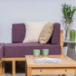 Close up of the purple sofas and of the Oak Natural  Core Centre Table, a wooden coffee and centre table you can buy online at Sukham Home, a sustainable furniture, kitchen & dining and home decor store in Kolkata, India