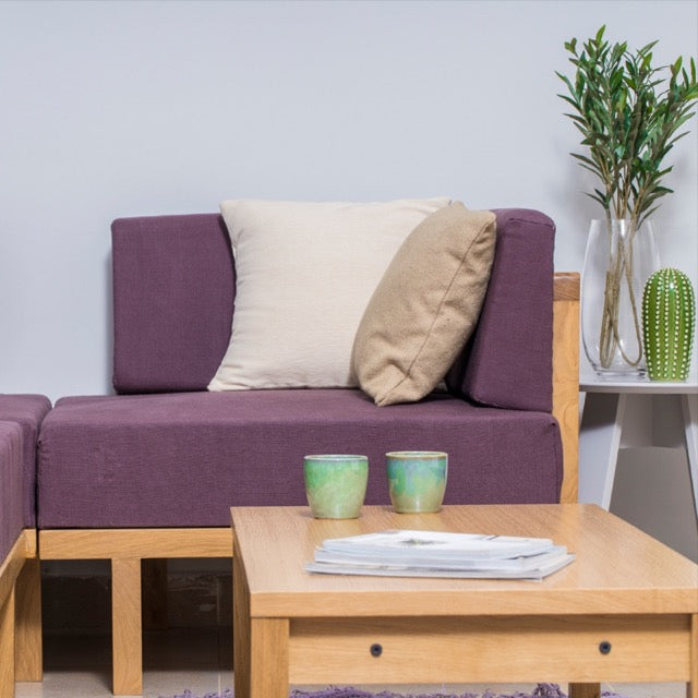 Close up of the purple sofas and of the Oak Natural  Core Centre Table, a wooden coffee and centre table you can buy online at Sukham Home, a sustainable furniture, kitchen & dining and home decor store in Kolkata, India