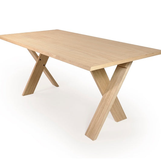 Against a white background, the top view of the Oak Natural Cross, a wooden long dining table you can buy online at Sukham Home, a sustainable furniture, kitchen & dining and home decor store in Kolkata, India