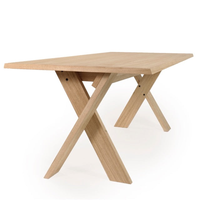 Side view of the Oak Natural Cross, a wooden long dining table you can buy online at Sukham Home, a sustainable furniture, kitchen & dining and home decor store in Kolkata, India