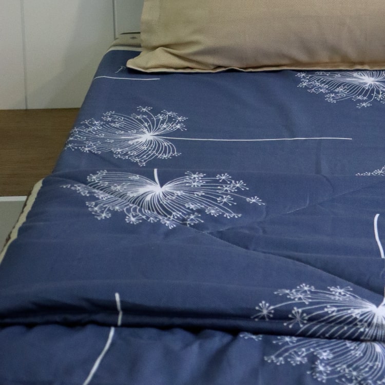 Along with the Dandelion Bedsheet, the Dandelion Blue-Grey Comforter, a blue and beige printed king size cotton quilt you can buy online at Sukham Home, a sustainable furniture, gardening and home decor store in Kolkata, India