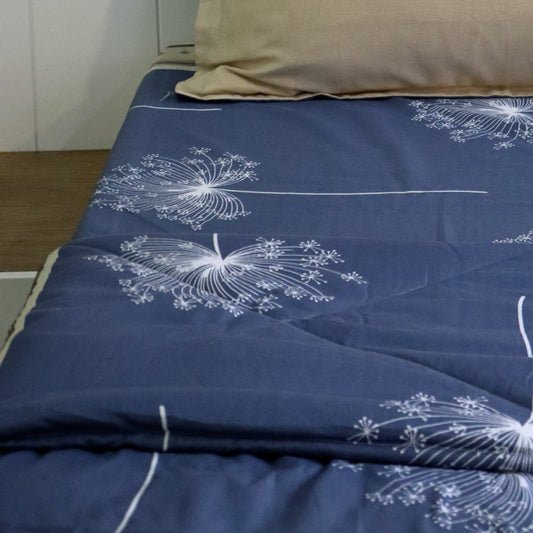 Along with the Dandelion Bedsheet, the Dandelion Blue-Grey Comforter, a blue and beige printed king size cotton quilt you can buy online at Sukham Home, a sustainable furniture, gardening and home decor store in Kolkata, India