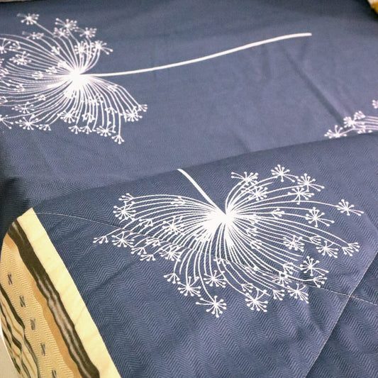 Close up of the pattern design and texture of the Dandelion Blue-Grey Printed Bedsheet, a blue and beige king size cotton bedsheet you can buy online at Sukham Home, a sustainable furniture, gardening and home decor store in Kolkata, India