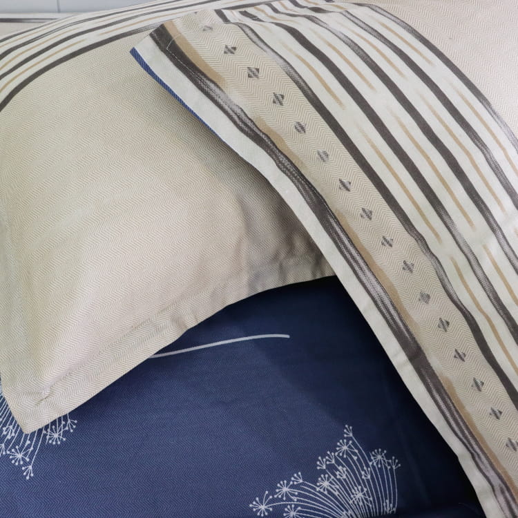 Reversible pillows of the Dandelion Blue-Grey Printed Bedsheet, a blue and beige king size cotton bedsheet you can buy online at Sukham Home, a sustainable furniture, gardening and home decor store in Kolkata, India