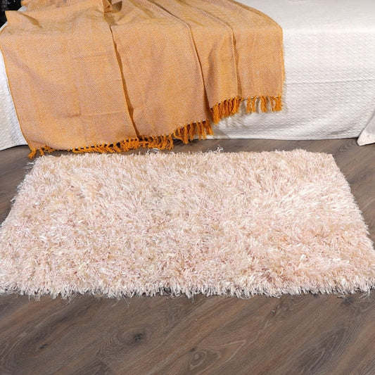 On the foot of the bed, the Dori Shag Rug, a rectangle shaggy cotton carpet in pale pink you can buy online at Sukham Home, a sustainable furniture, kitchen & dining and home decor store in Kolkata, India