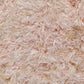 Close up of the shaggy texture and fringes on the Dori Shag Rug, a rectangle shaggy cotton carpet in pale pink you can buy online at Sukham Home, a sustainable furniture, kitchen & dining and home decor store in Kolkata, India