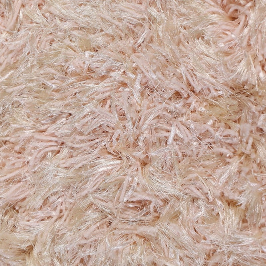 Close up of the shaggy texture and fringes on the Dori Shag Rug, a rectangle shaggy cotton carpet in pale pink you can buy online at Sukham Home, a sustainable furniture, kitchen & dining and home decor store in Kolkata, India