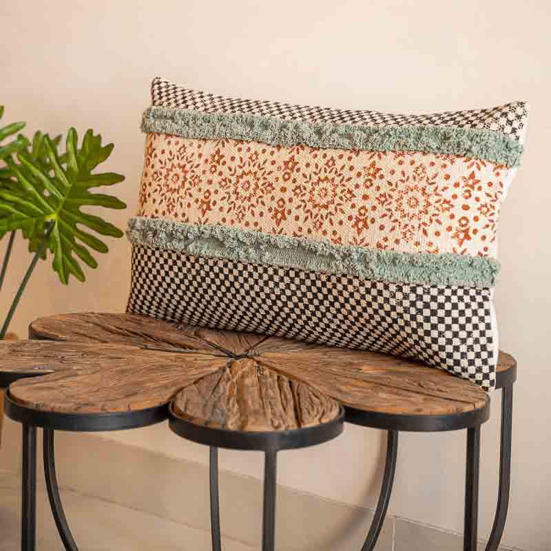 Distant front view of the Elysian Fringed Cushion, a rectangle handpainted and tufted accent pillow you can buy online at Sukham Home, a sustainable furniture, kitchen & dining and home decor store in Kolkata, India