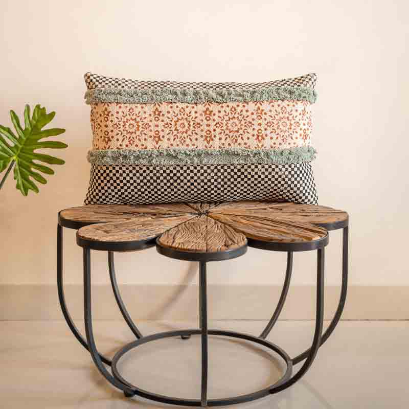 Placed on a table, a distant view of the Elysian Fringed Cushion, a rectangle handpainted and tufted accent pillow you can buy online at Sukham Home, a sustainable furniture, kitchen & dining and home decor store in Kolkata, India