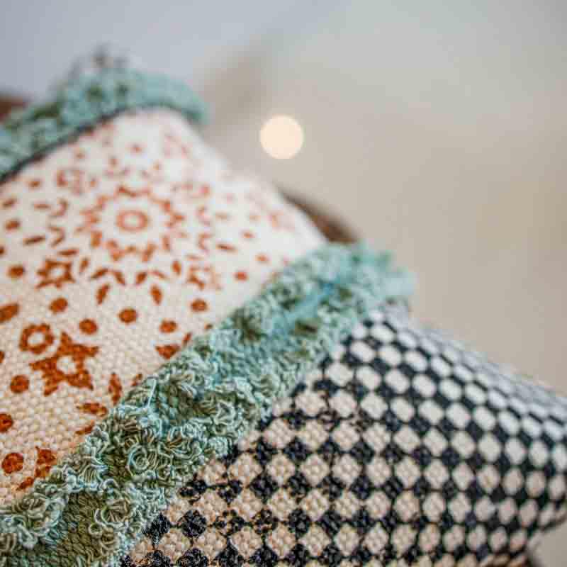 Close up of the threadwork of the Elysian Fringed Cushion, a rectangle handpainted and tufted accent pillow you can buy online at Sukham Home, a sustainable furniture, kitchen & dining and home decor store in Kolkata, India