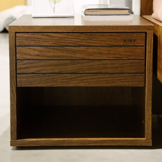 Front view of the Walnut Natural Facile, a wooden bedside table with a slatted drawer and cubby storage you can buy online at Sukham Home, a sustainable furniture, kitchen & dining and home decor store in Kolkata, India